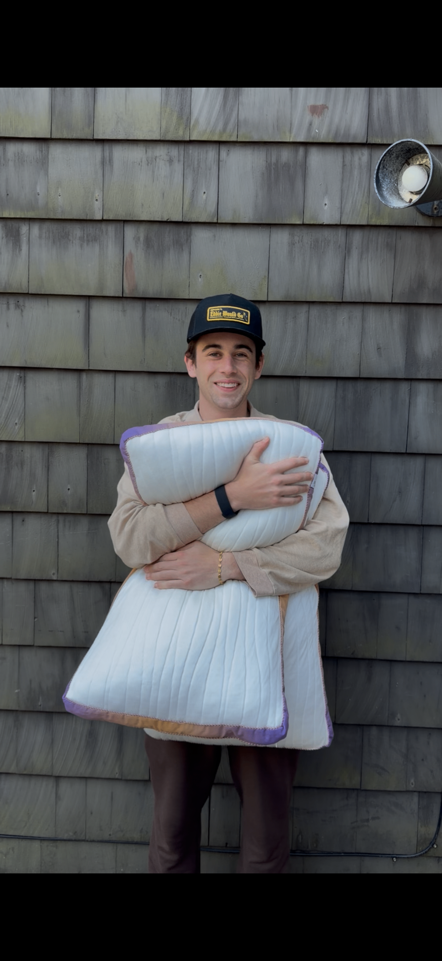 Dylan Silverstein, founder of Stigma Sleep, holding the Original Stigma Sleep Adjustable Pillow