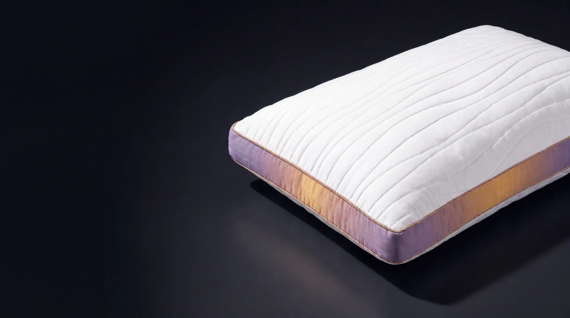 Stigma Sleep adjustable memory foam pillow lit on a dark stage